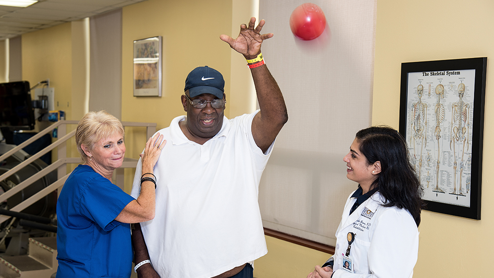 Photo of Therapist and physician working with a patient