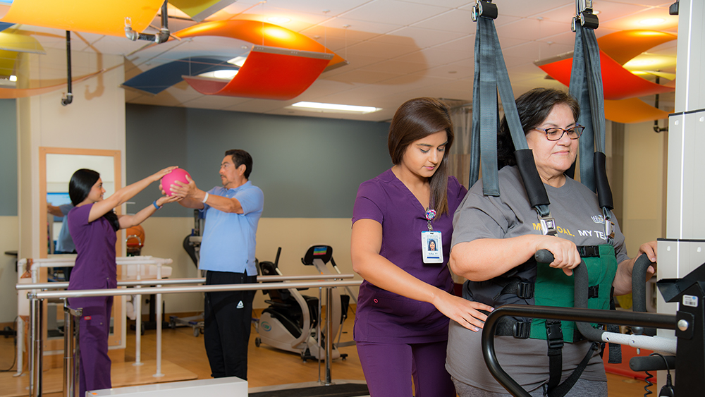 Photo of TIRR therapists with rehabilitation patients at Greater Heights Inpatient location