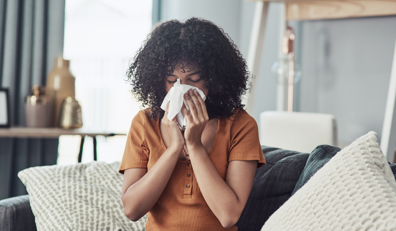 Woman blowing her nose