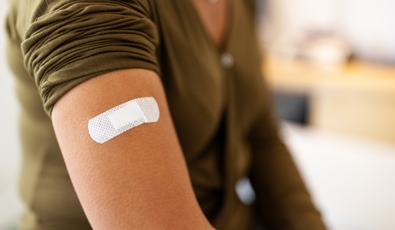 A woman has just received a shot at the doctor's office