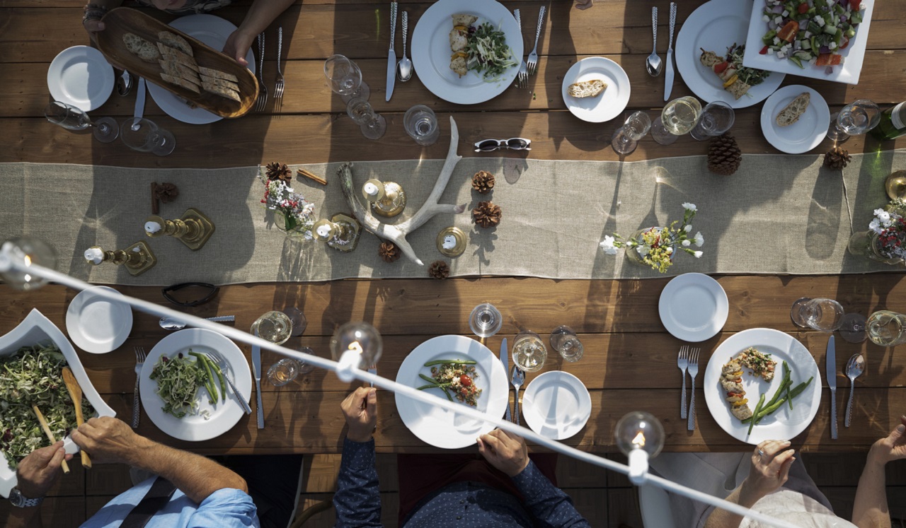 A dining table with meats and vegetables