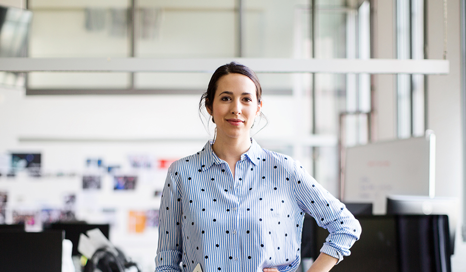 A portrait of a woman in an office setting. 