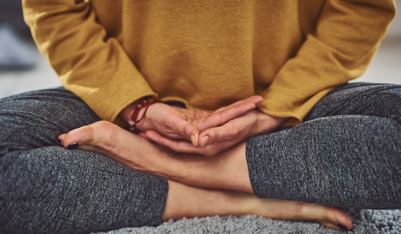 A person sitting in a yoga or meditative pose.