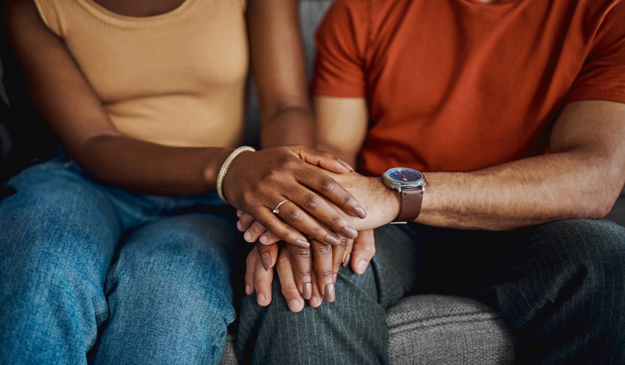 Two people holding hands