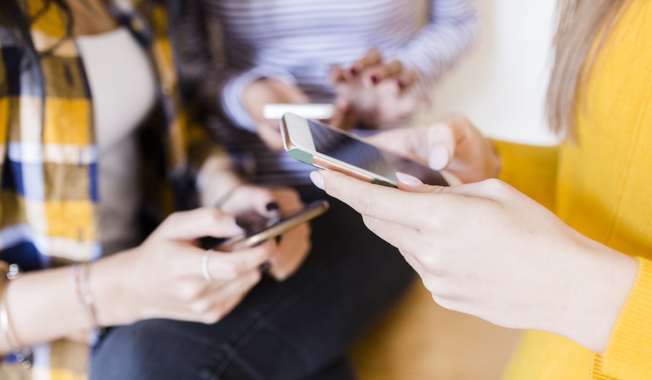 A group of people on their phones.