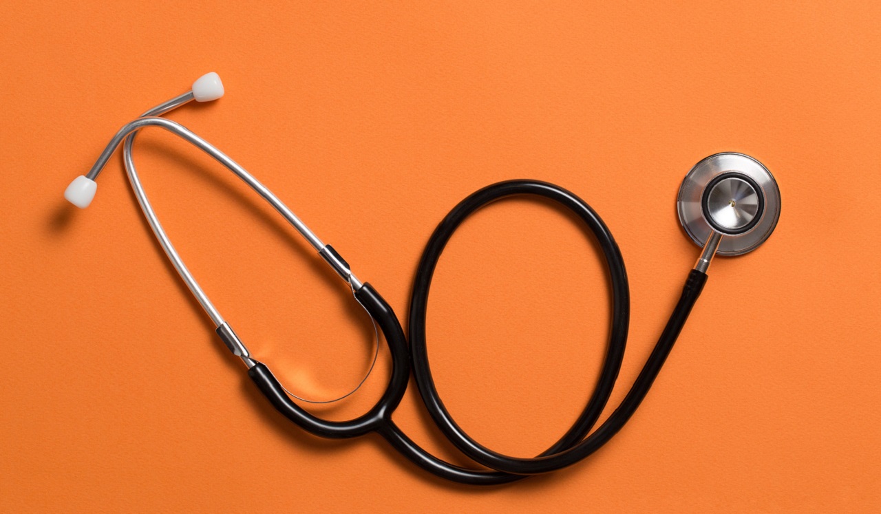 Stethoscope on orange background