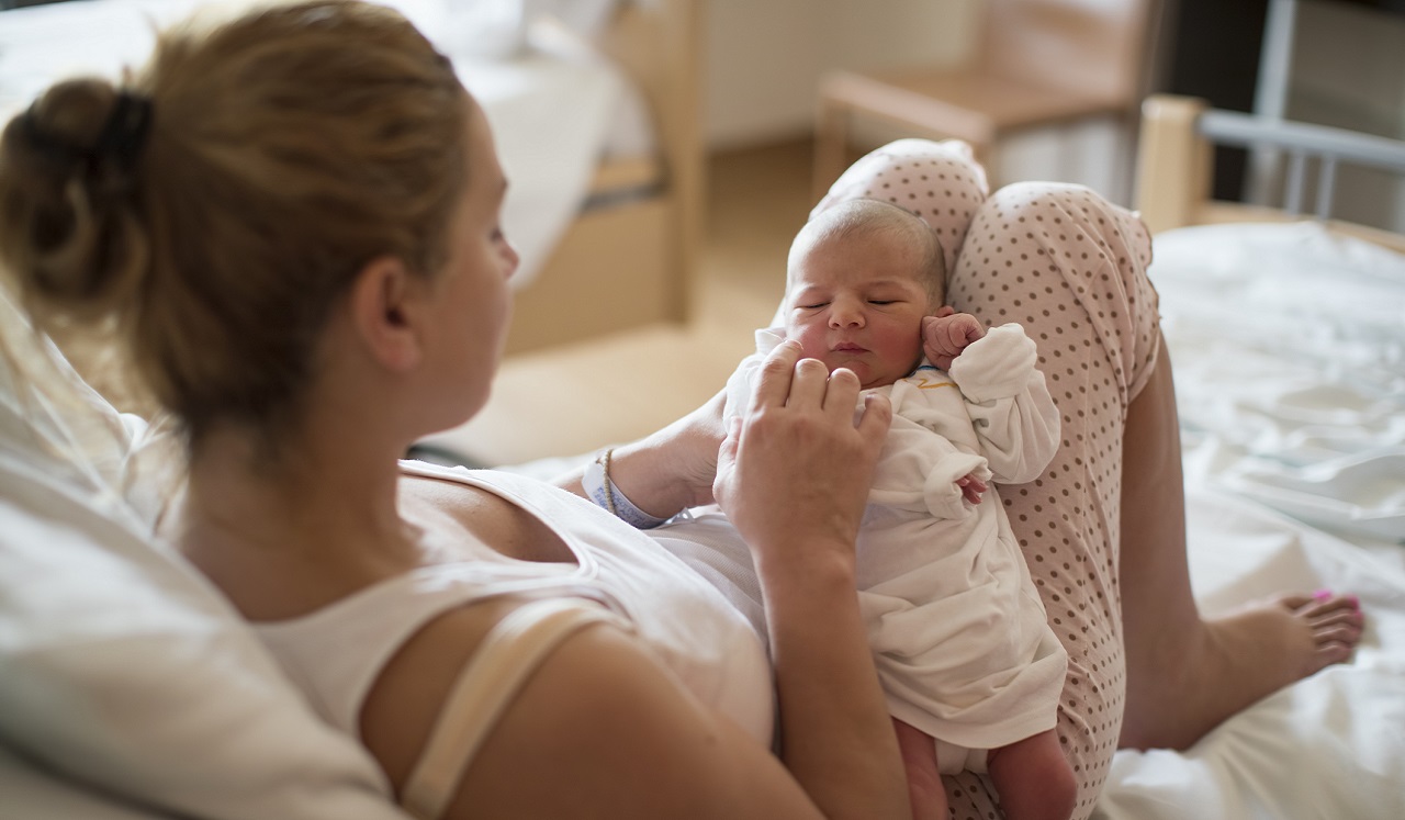 A mother holding her new born baby.