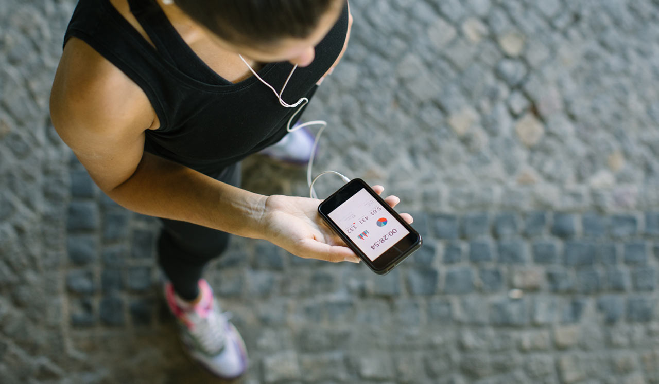 Woman in athletic gear looking at phone