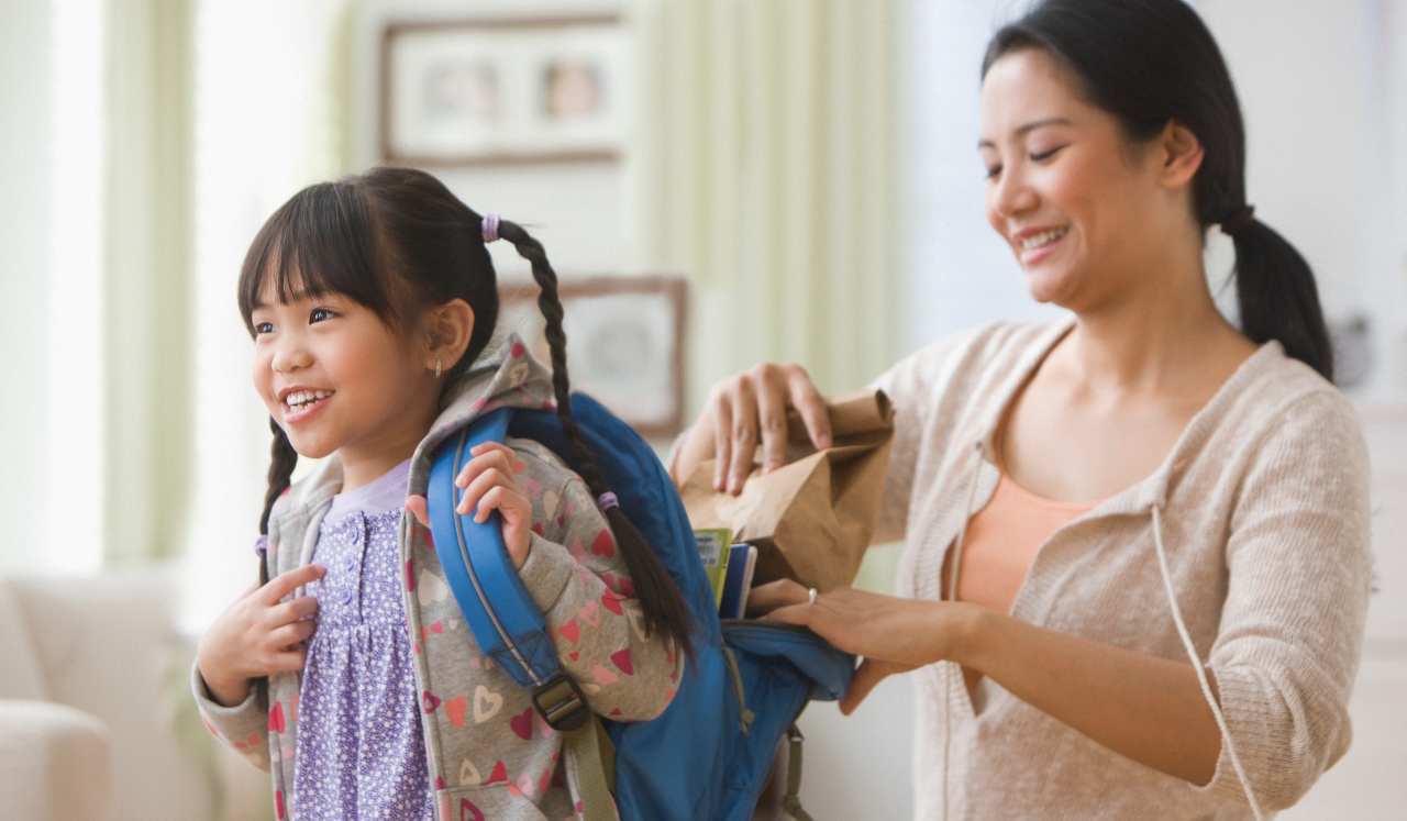 Parent packing child's backpack