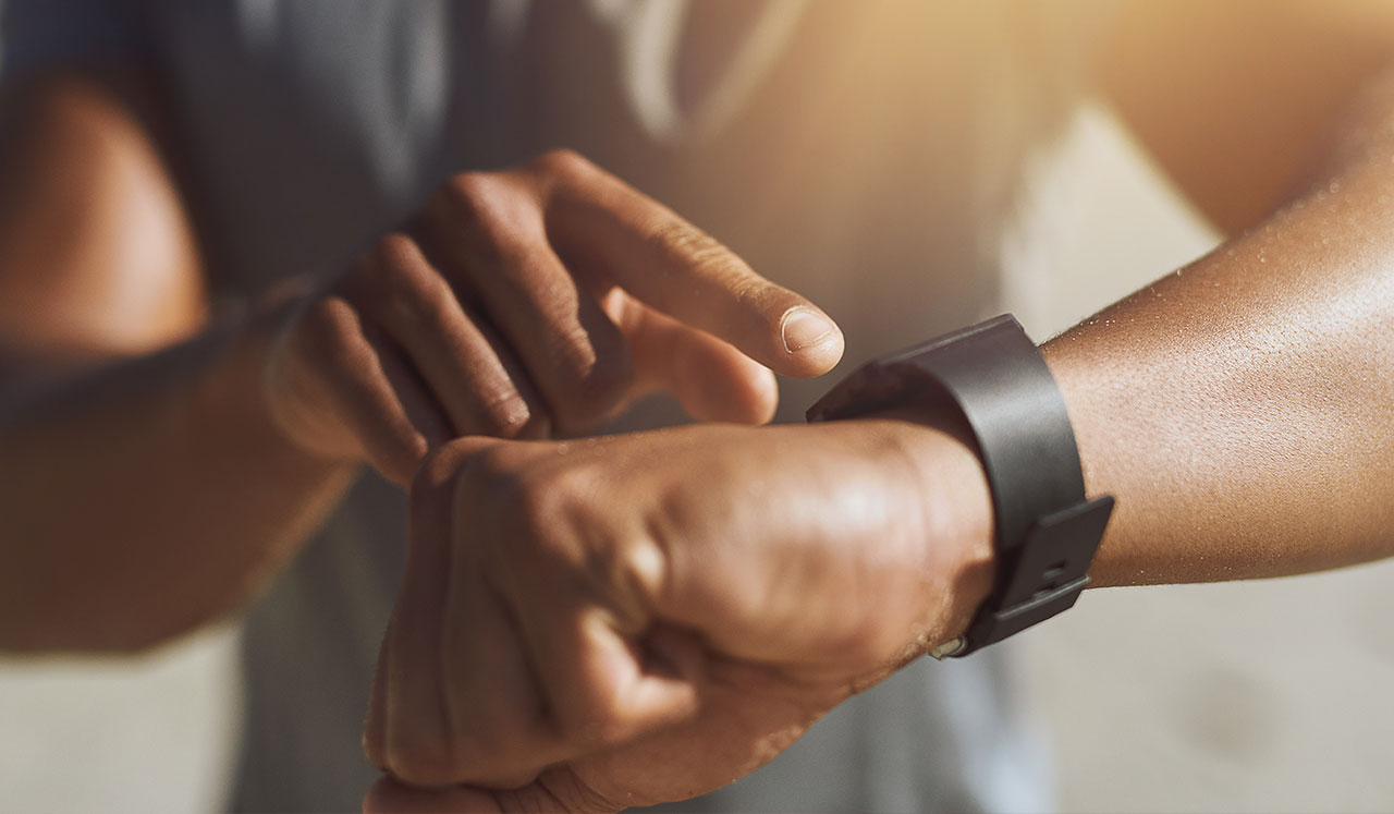 A man checking his fitness watch.