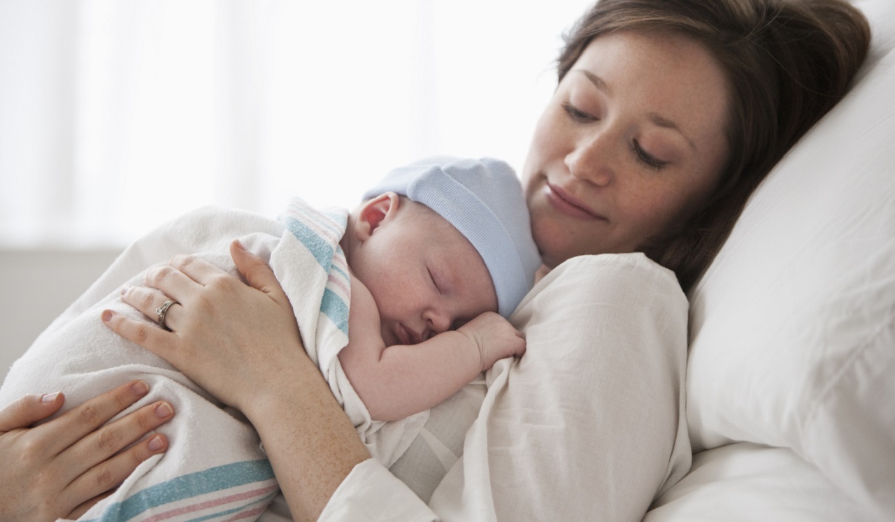 A mother holding her baby.