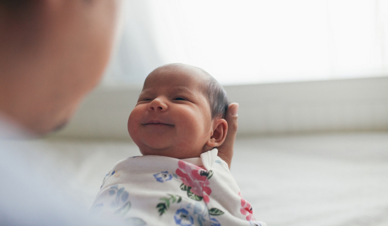 A newborn baby being held.