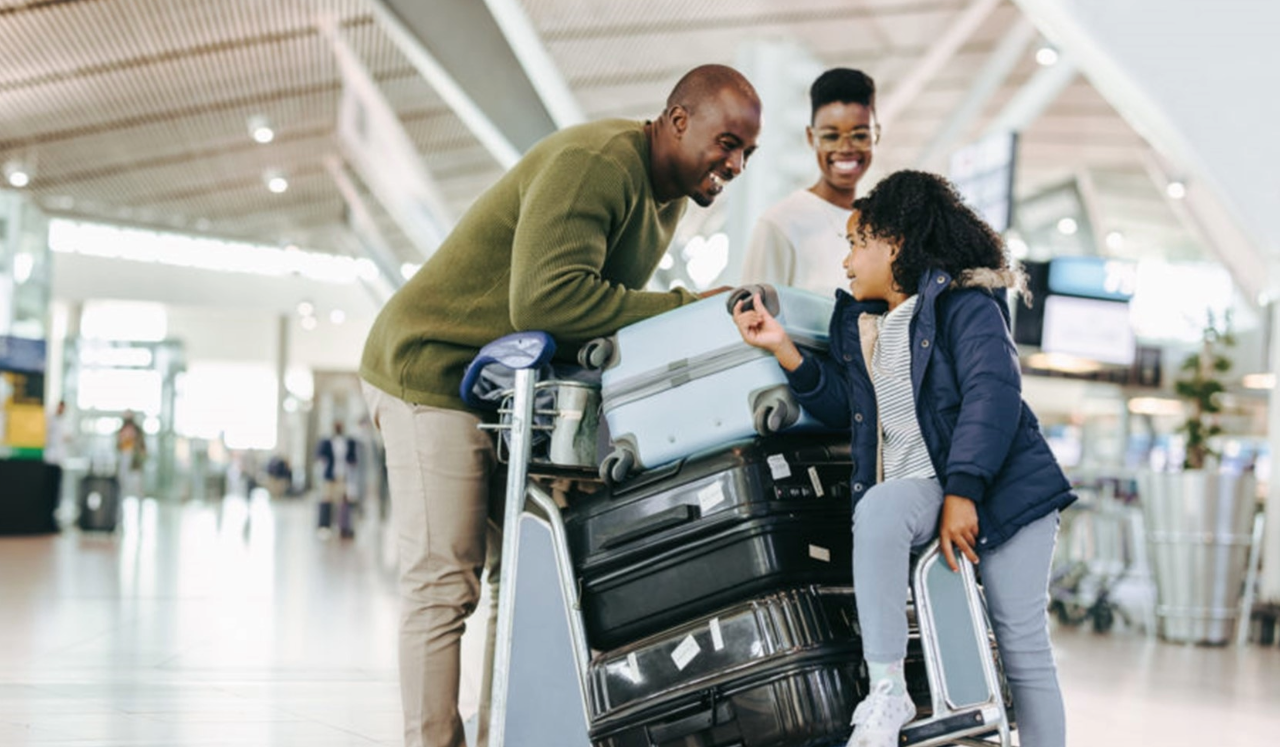 Family with suitcases at airport