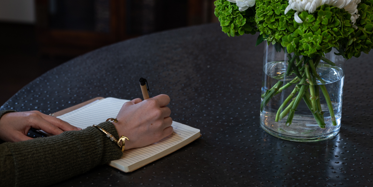 A woman writing in a notebook.