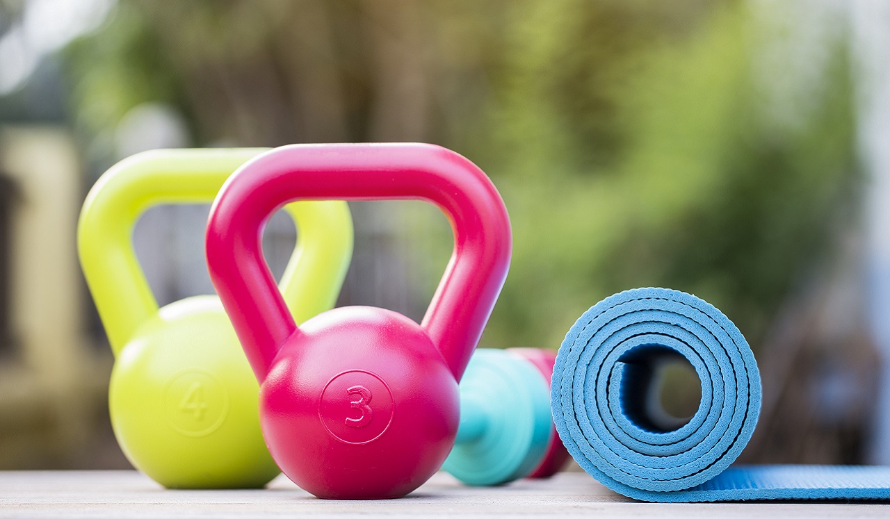 Yoga mat and kettlebells arranged for a workout.