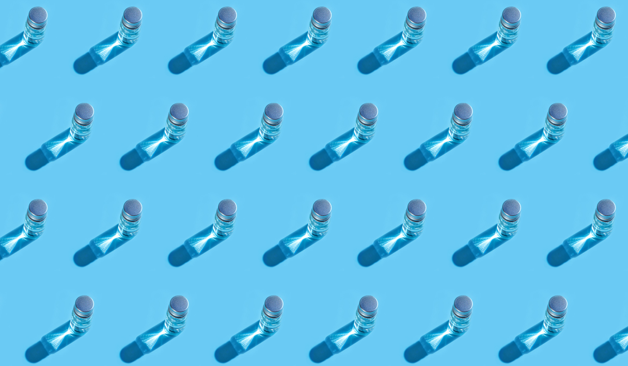 Vaccine vials arranged in a pattern on a blue background