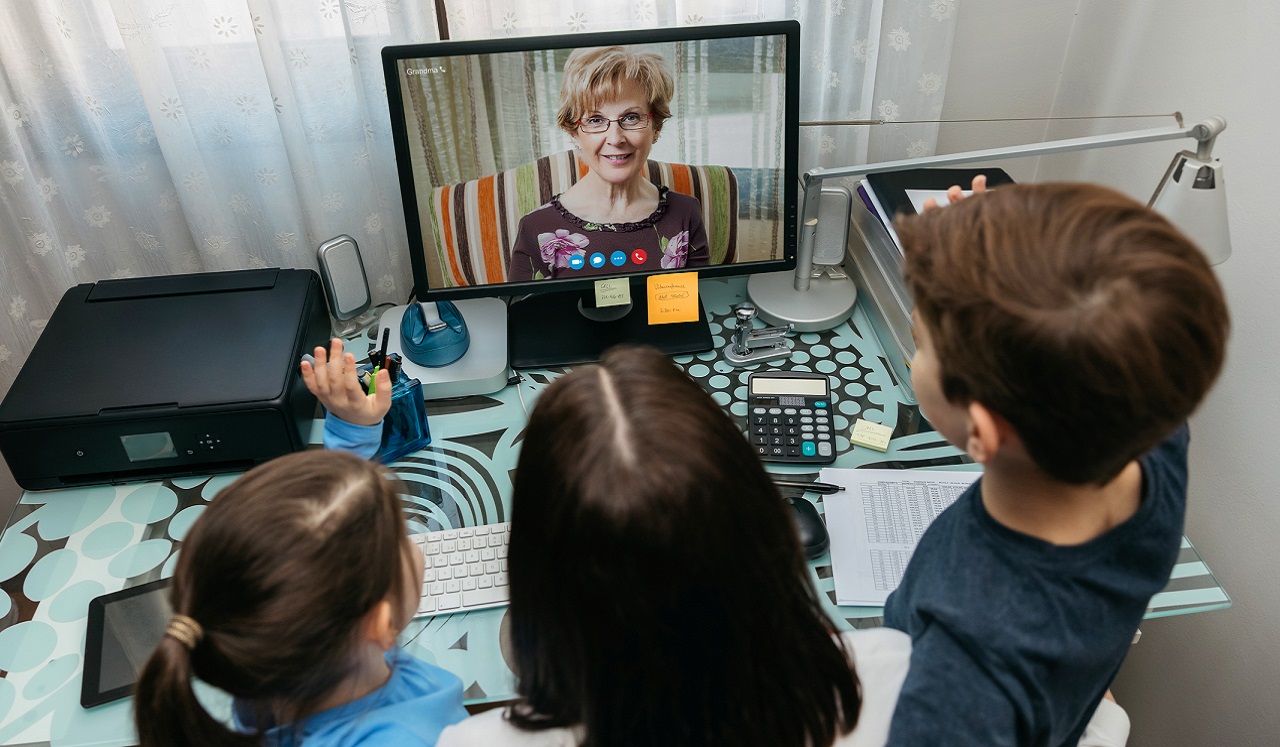 Children looking at their grandmother on a screen