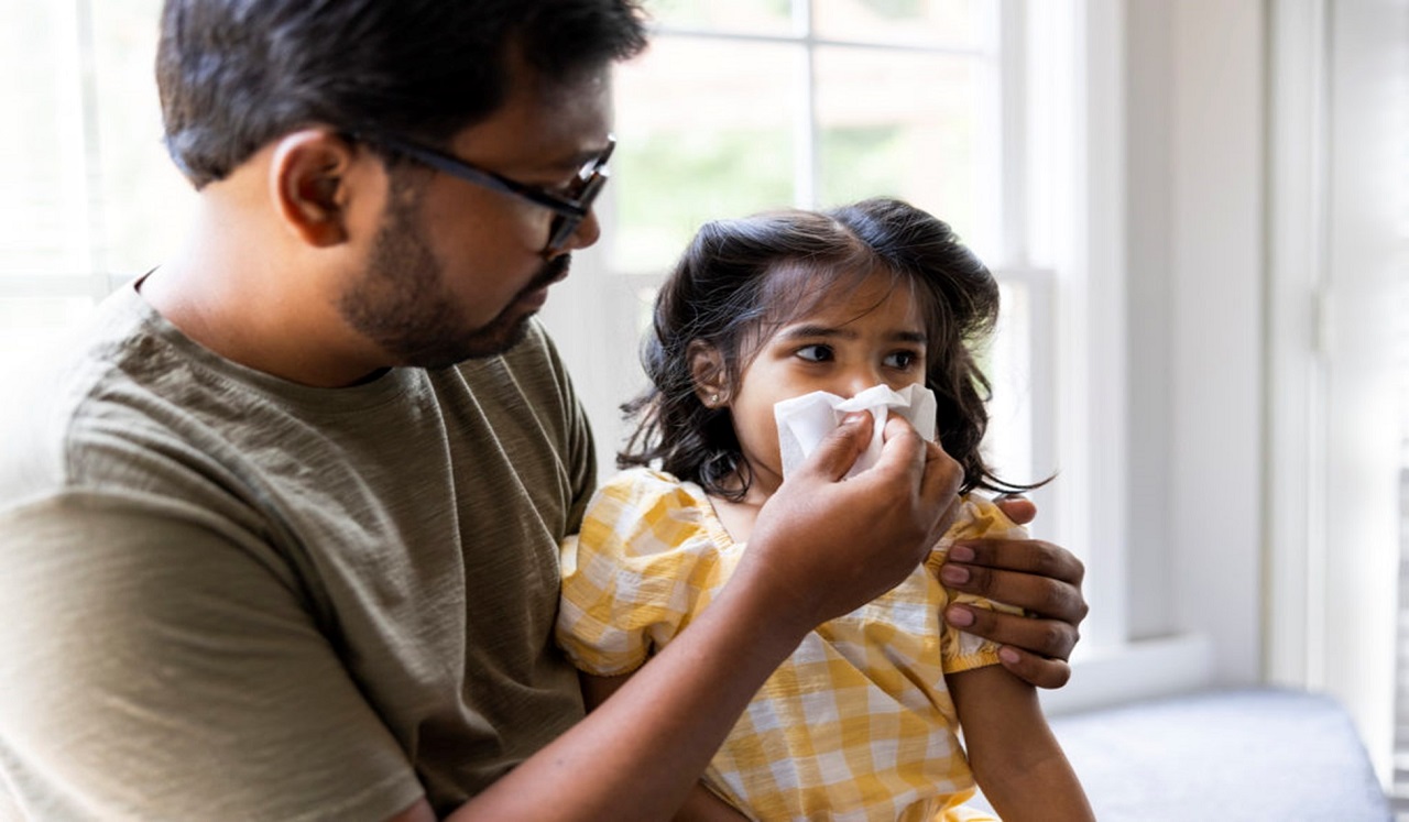 Parent helping sick child