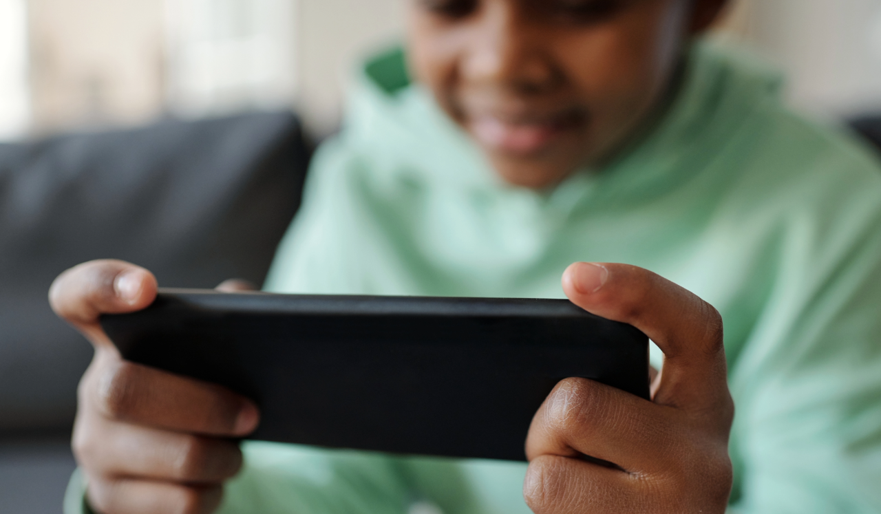 Child staring at tablet.