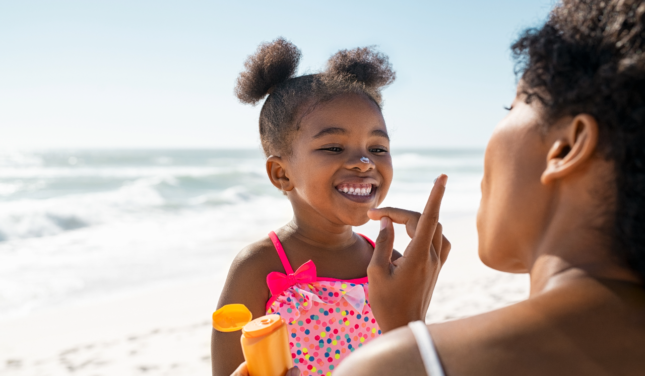 Woman putting sunscreen on child