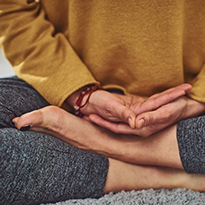 A person sitting in a yoga or meditative pose.