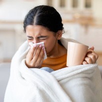 Woman sick and sneezing