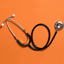 Stethoscope on orange background