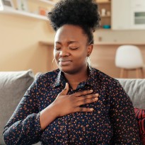 Woman clutching chest