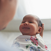 A newborn baby being held.