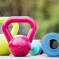 Yoga mat and kettlebells arranged for a workout.