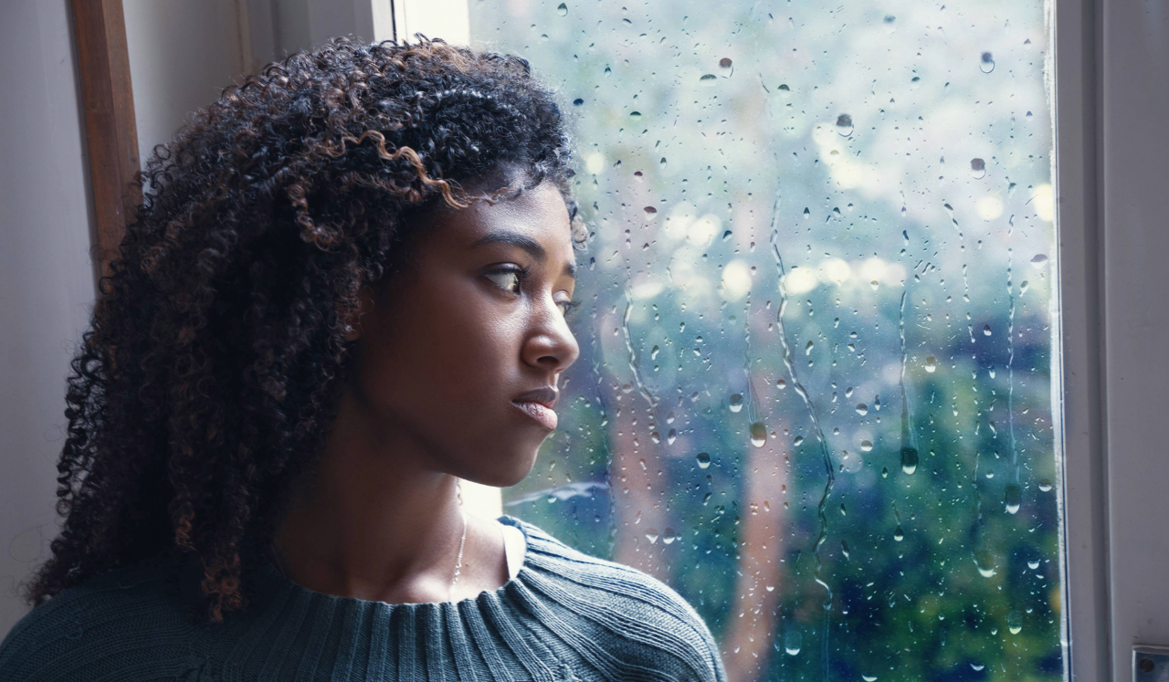 Woman looking outside of window