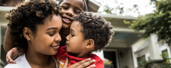 A woman and children embracing