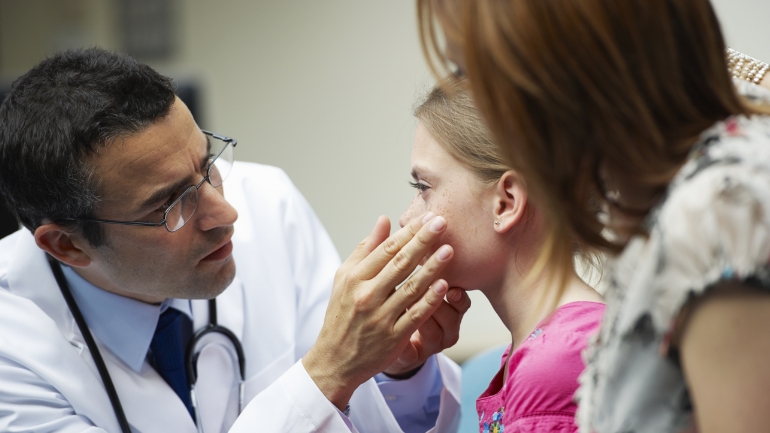 Doctor touching patient face