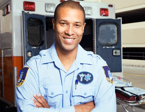 Paramedic in front of ambulance