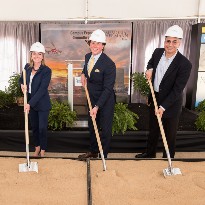 Three people digging dirt