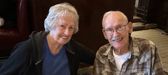 Cancer survivor, Deanna Owens smiles with her husband on a dinner date. 