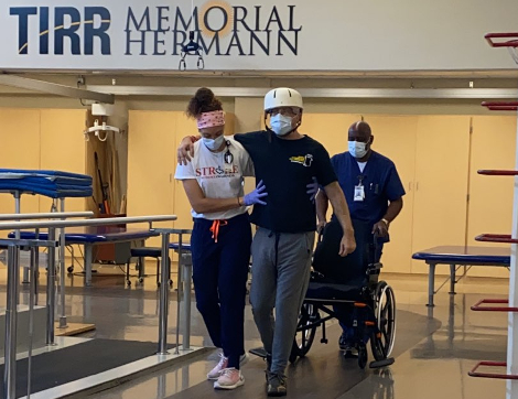 TIRR Memorial Hermann patient, Eric Blumentritt, walks with therapists at the track.