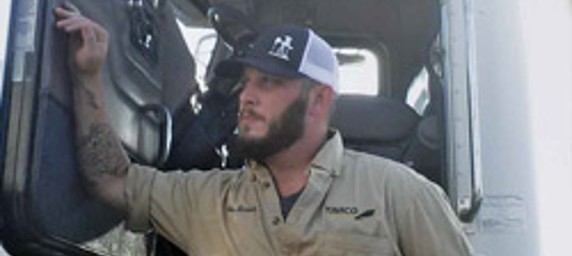 TIRR Memorial Hermann patient, Wes Brown, leans on his rig after returning to work.