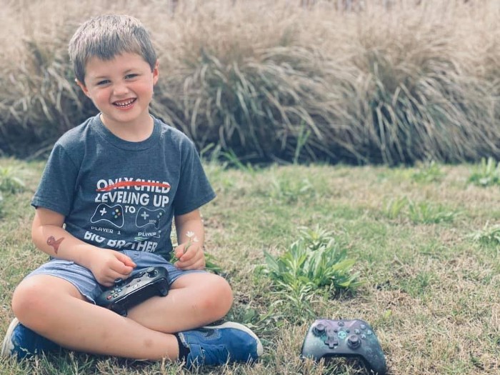 patient landon sitting on grass