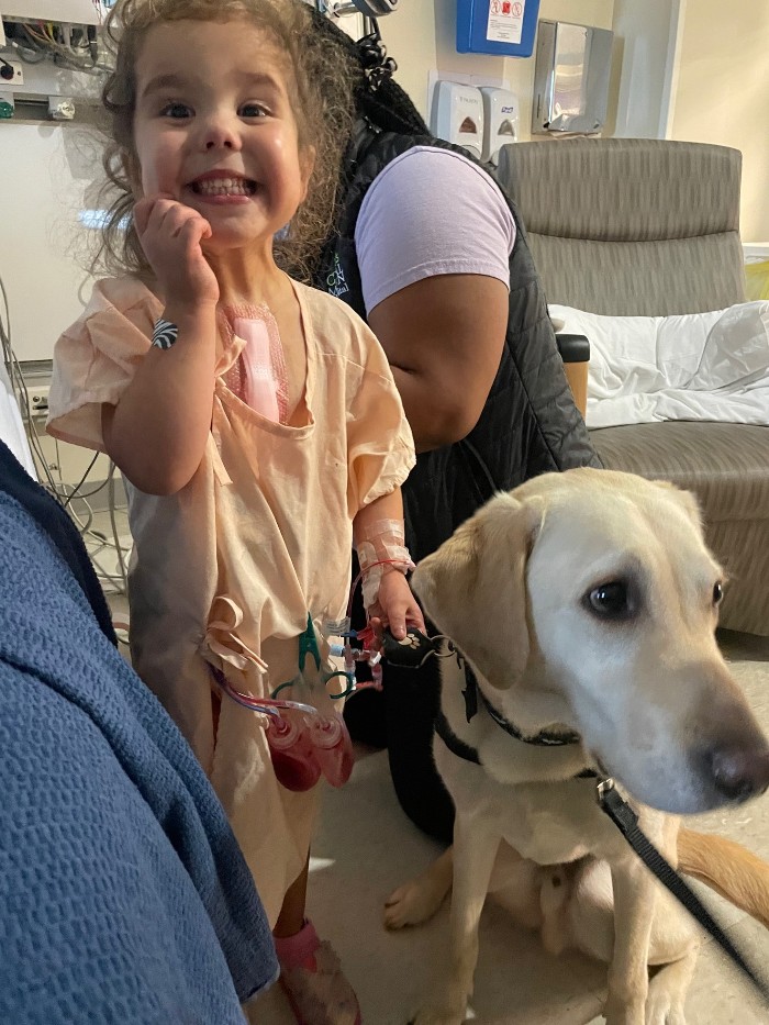 patient dottie in hospital with facility dog 