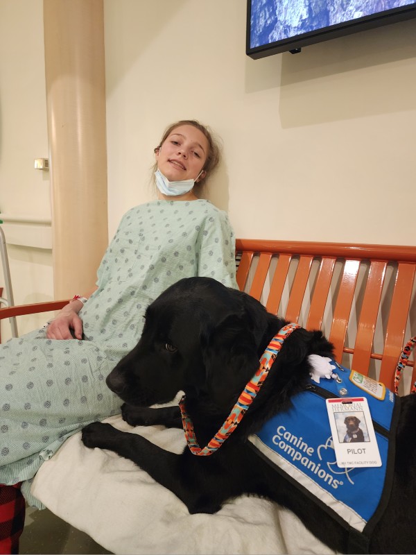 patient kaylah and facility dog dexter