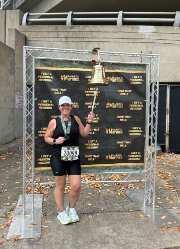 Katie Payne, NewStart success story, rings the bell following her marathon finish.