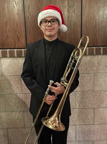 TIRR Memorial Hermann patient, Jacob, stands with his musical instrument