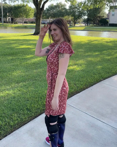 TIRR Memorial Hermann patient, Kelli Bixler, smiles in the shade on a sunny day.