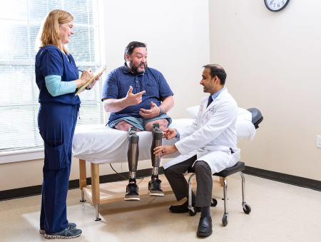 TIRR Memorial Hermann Osseointegration patient, Alex, talks with his physician.