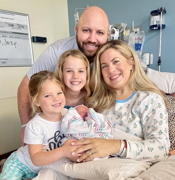 patient posing with family in hospital bed