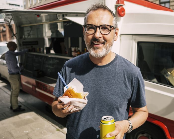 Man eating lunch from food truck