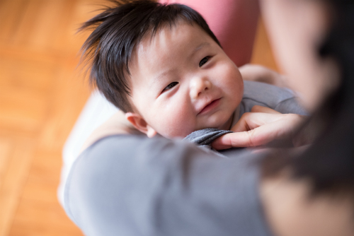 Woman looking down at baby