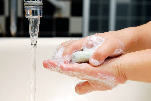 Child hands covered in soap