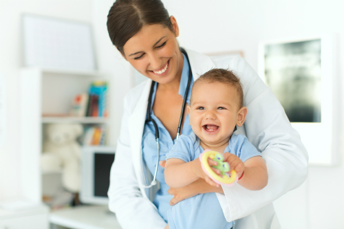 Smiling baby and doctor